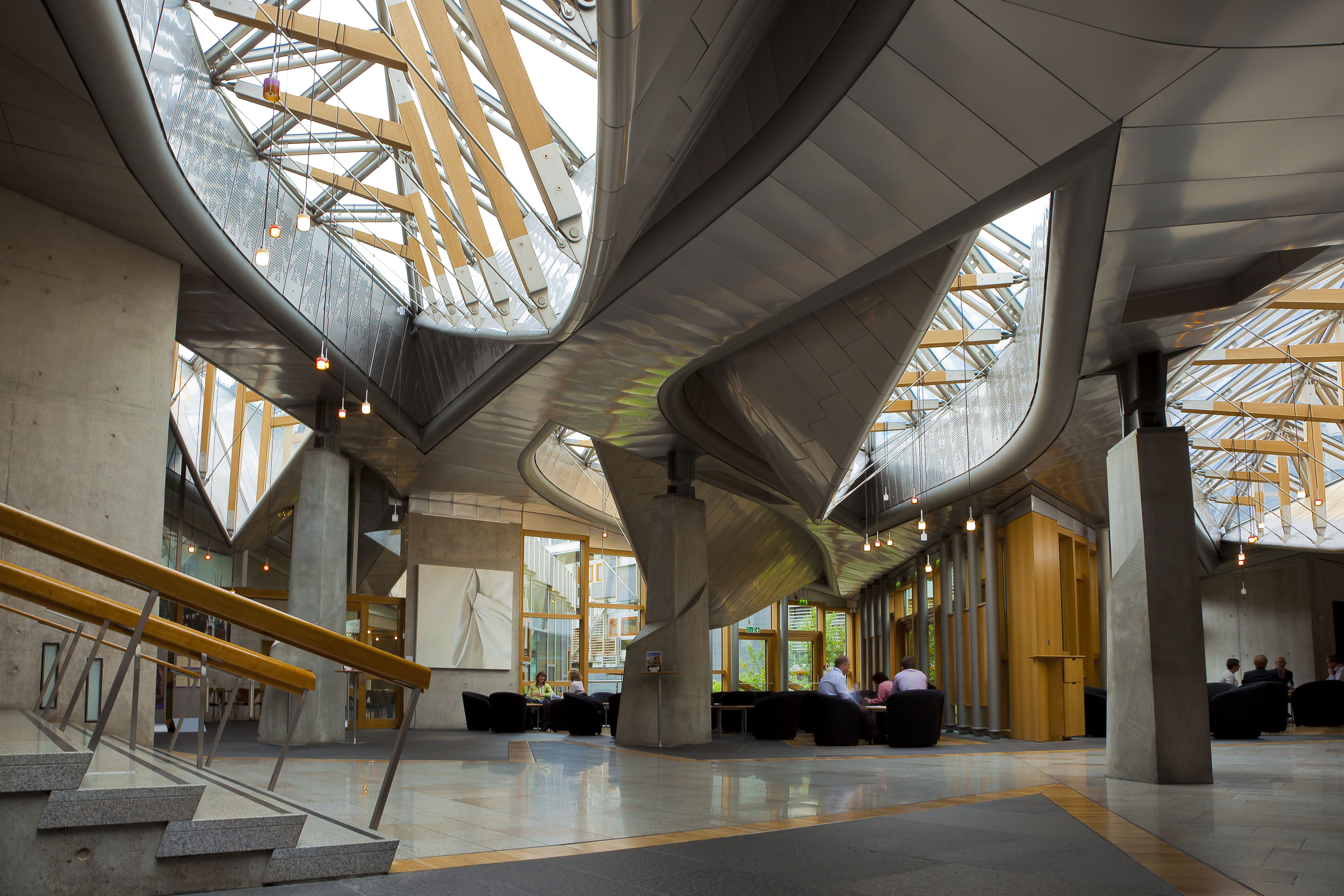 The Garden Lobby in the Scottish Parliament. There are large oval glass windows in the roof.