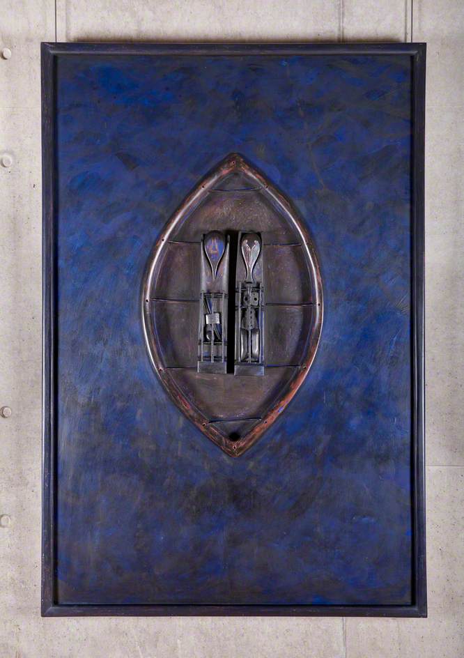 Wood and mixed media wall-mounted artwork in dark blue colours. In centre is a small oval-shaped boat, as if viewed from above. Inside the boat are two figures, one like a gannet one like a fish, and supplies for building shelters or preparing food.